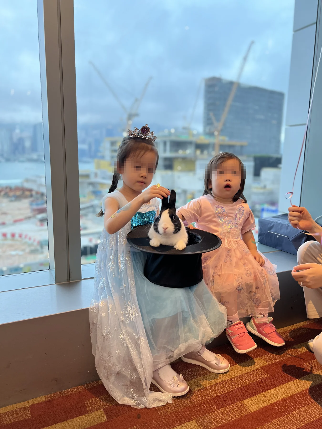 Children meeting Magical Guy rabbit by the window