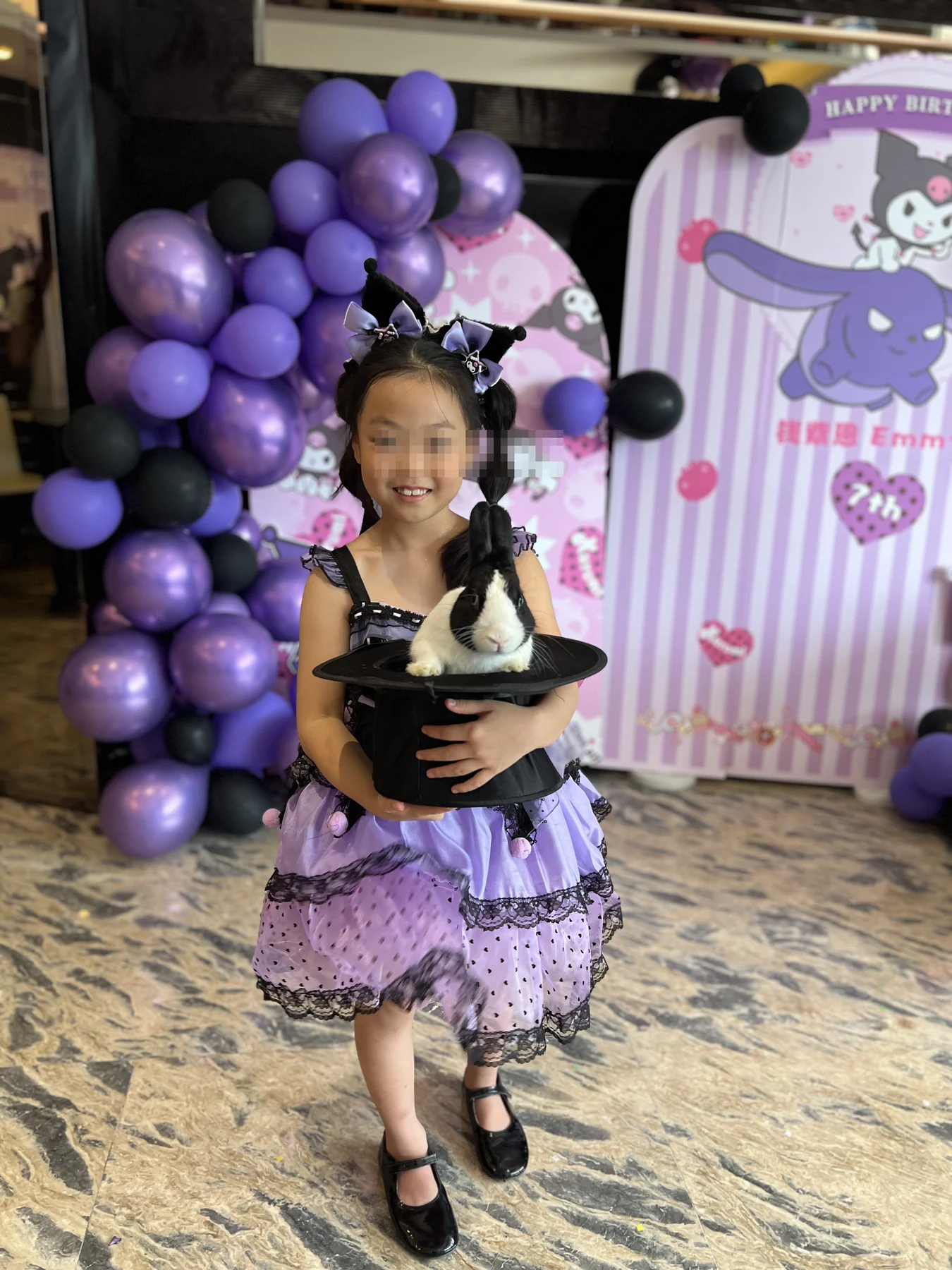 Birthday child holding a magician hat with a rabbit