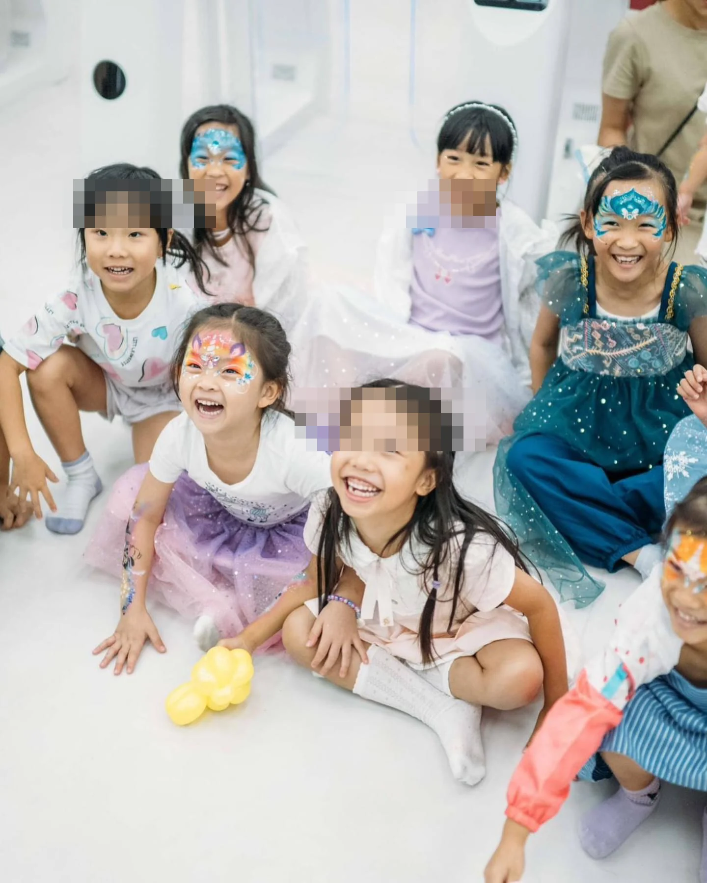 Children smiling after face painting at a Magical Guy party