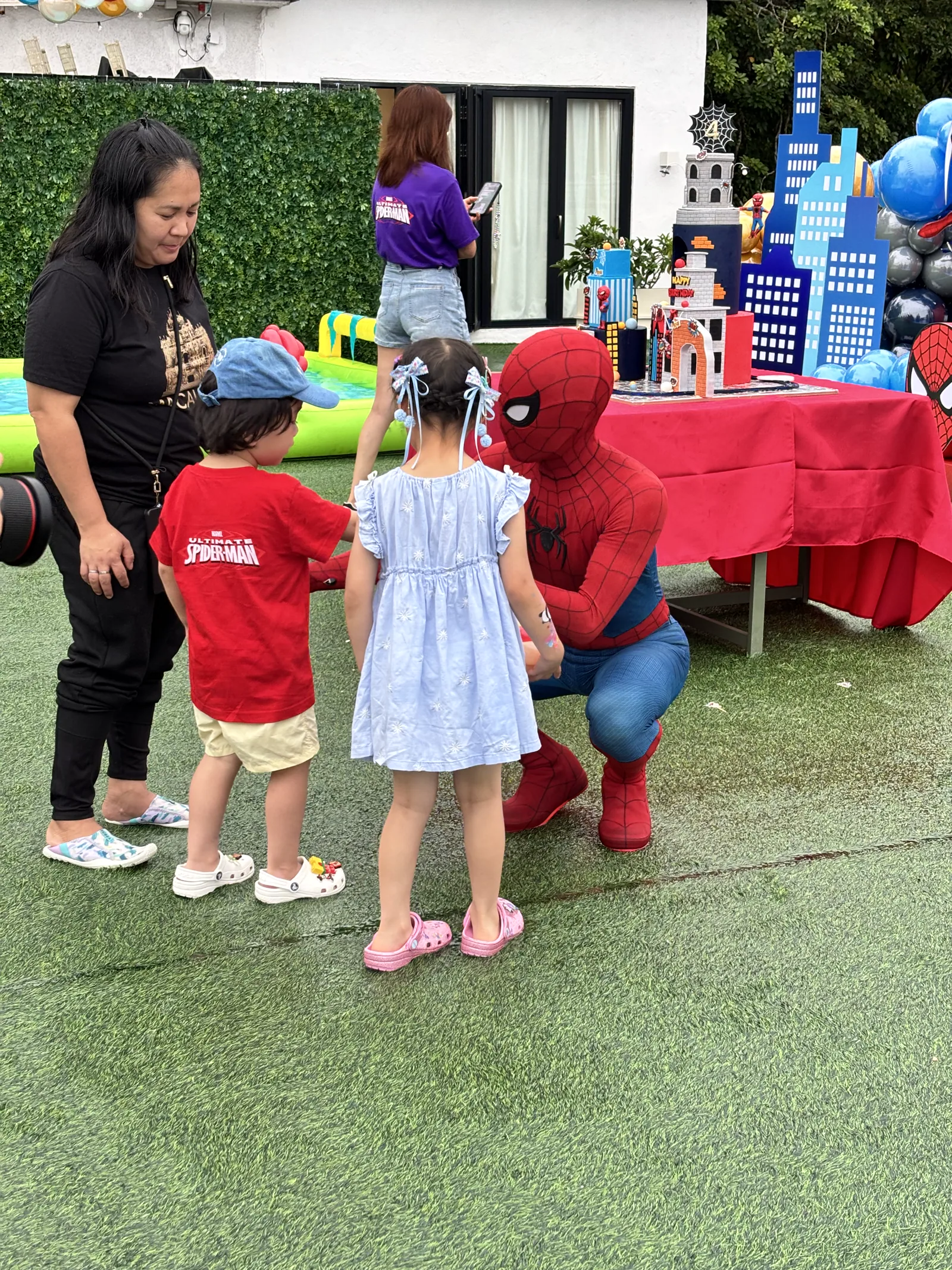 Spider-Man interacting with children during a birthday party