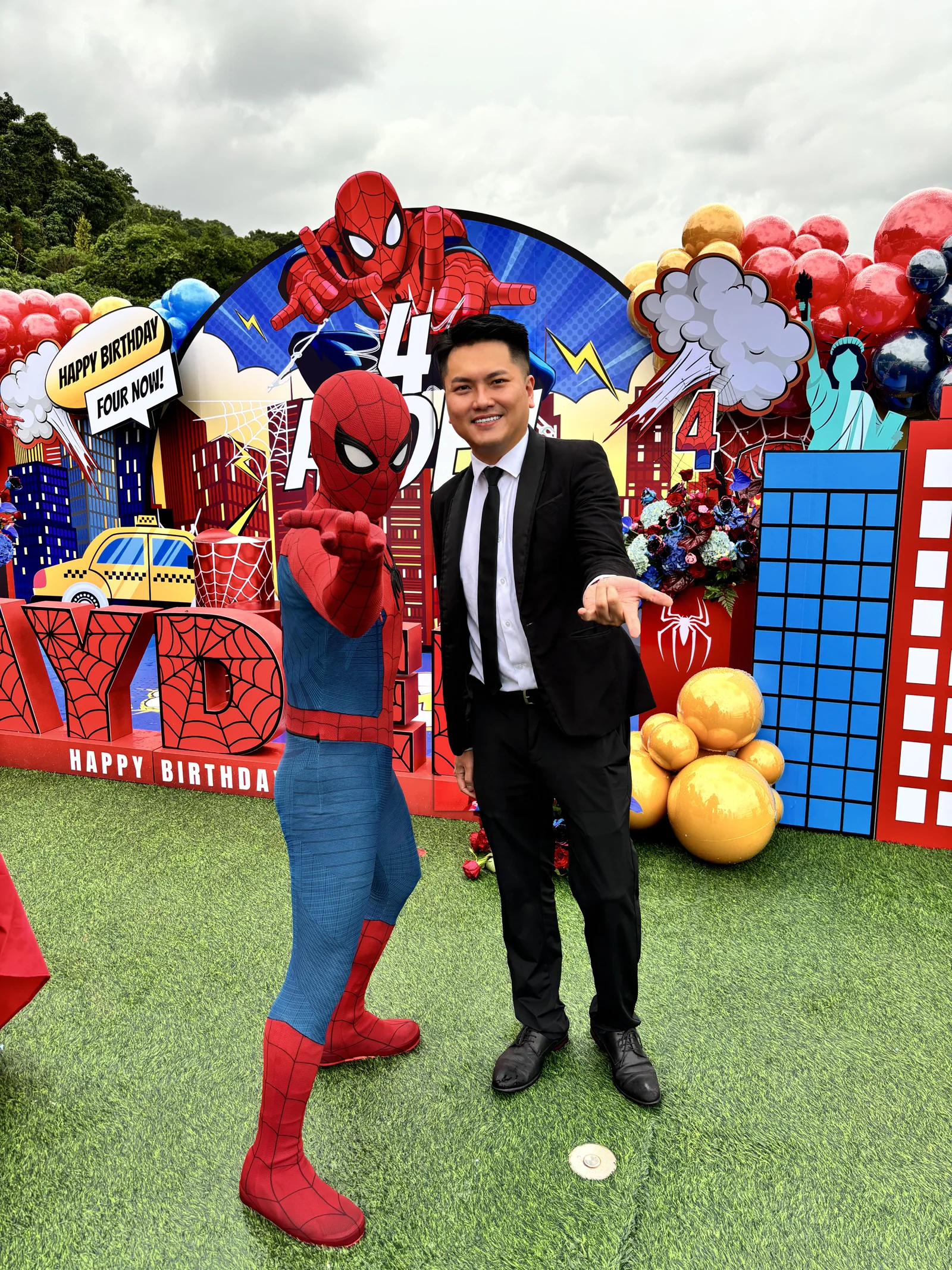 Spider-Man and suited magician photo moment at a superhero birthday party